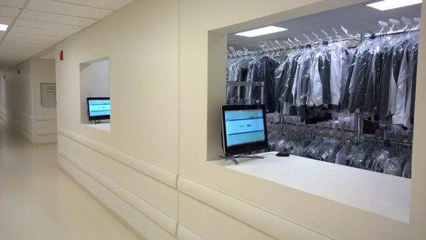 White nice room with full of uniform and a computer